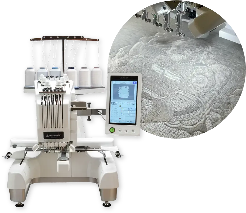 Embroidery machine stitching a design in white thread